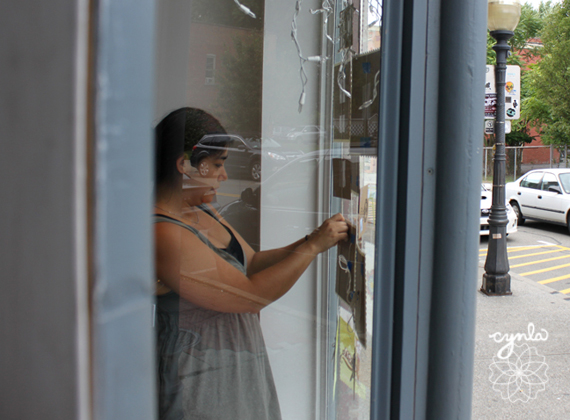 Putting up a window display - Cindy LaColla