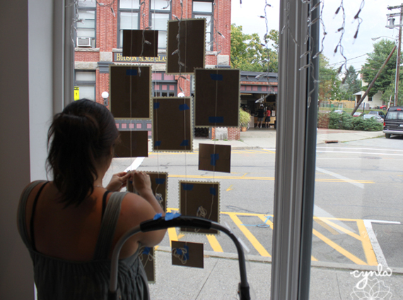 Putting up a window display - Cindy LaColla