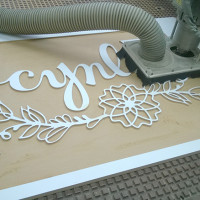 wooden Sign cutting for a tradeshow booth - Cynla Logo